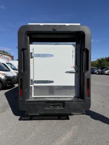 Rear view of a BrightDrop van with an insulated cargo door and diamond-plate kick plate, upfitted by Prisco Vans Montreal